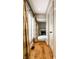 Hallway with hardwood floors leading to a living room featuring a fireplace and large windows at 9550 Copley Dr, Indianapolis, IN 46260