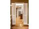 View through open doors to hardwood floors, brick accent wall, and built in shelving at 9550 Copley Dr, Indianapolis, IN 46260
