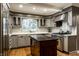 Bright kitchen boasts a central island, stainless steel appliances, and updated finishes for a modern cooking experience at 9550 Copley Dr, Indianapolis, IN 46260
