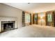 Spacious living room featuring a fireplace, large windows, and neutral carpet at 9550 Copley Dr, Indianapolis, IN 46260