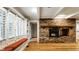 Spacious living room with a brick fireplace, window seat, and built in shelving at 9550 Copley Dr, Indianapolis, IN 46260