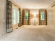 Bright living room with neutral carpet, large windows, and custom curtains at 9550 Copley Dr, Indianapolis, IN 46260