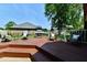 Relax on the spacious deck featuring a grill, comfortable seating, and well maintained greenery, perfect for outdoor living at 1010 Lakewood N Dr, Brownsburg, IN 46112