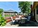 Back patio featuring dining area and grill on spacious deck surrounded by greenery, perfect for outdoor entertaining at 1010 Lakewood N Dr, Brownsburg, IN 46112