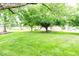 Expansive backyard with lush green lawn and mature trees provides ample space for outdoor activities at 1010 Lakewood N Dr, Brownsburg, IN 46112