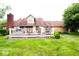Spacious backyard featuring a deck, lush green lawn, and mature trees at 1010 Lakewood N Dr, Brownsburg, IN 46112
