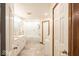 Bright bathroom featuring a double vanity, soaking tub with glass enclosure, and neutral tile flooring at 1010 Lakewood N Dr, Brownsburg, IN 46112