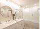 Bright bathroom featuring a double sink vanity with framed mirrors and updated lighting at 1010 Lakewood N Dr, Brownsburg, IN 46112