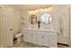 Well-lit bathroom featuring double sinks, quartz countertops, and modern fixtures at 1010 Lakewood N Dr, Brownsburg, IN 46112