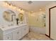 Bright bathroom featuring double vanity sinks, modern lighting, and a glass-enclosed shower/tub combo at 1010 Lakewood N Dr, Brownsburg, IN 46112