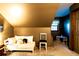 Attic bedroom with neutral walls, area rug, dark accent wall and play area at 1010 Lakewood N Dr, Brownsburg, IN 46112