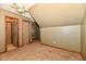This spacious bedroom has neutral carpeting and an angled ceiling with a ceiling fan at 1010 Lakewood N Dr, Brownsburg, IN 46112