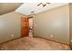 Neutral bedroom shows a ceiling fan, and an open wood door that leads to the stairway at 1010 Lakewood N Dr, Brownsburg, IN 46112