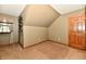 Angled ceiling bedroom features neutral walls, carpeting, and a wood door with windows at 1010 Lakewood N Dr, Brownsburg, IN 46112