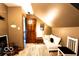 Attic bedroom with daybed, dark accent wall and play area at 1010 Lakewood N Dr, Brownsburg, IN 46112