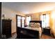 Comfortable bedroom with a queen-sized bed, bedside tables, and a view of the backyard at 1010 Lakewood N Dr, Brownsburg, IN 46112