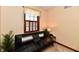 Cozy bedroom showcasing a black futon sofa, wood shuttered window, and neutral decor at 1010 Lakewood N Dr, Brownsburg, IN 46112