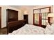 Bedroom featuring dark wood furniture, french doors, and warm lighting at 1010 Lakewood N Dr, Brownsburg, IN 46112