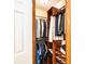 Organized walk-in closet with wooden shelves, hanging rods, and space for shoes and folded garments at 1010 Lakewood N Dr, Brownsburg, IN 46112