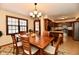 Inviting dining room with wood table and chairs, stylish lighting, and a view into the kitchen at 1010 Lakewood N Dr, Brownsburg, IN 46112