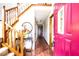 Inviting entryway with hardwood floors, staircase, and a view of the hallway and front door at 1010 Lakewood N Dr, Brownsburg, IN 46112