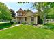 Charming two-story home with a turret, lush green lawn, and mature trees around the property at 1010 Lakewood N Dr, Brownsburg, IN 46112