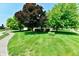 Well-maintained lawn and landscaping provides an inviting approach to this cozy home at 1010 Lakewood N Dr, Brownsburg, IN 46112