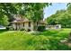 Charming two-story home featuring a spacious front yard, lush landscaping, and wooden deck at 1010 Lakewood N Dr, Brownsburg, IN 46112