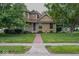 Charming two-story home with a well-manicured front yard, mature trees, and inviting front porch at 1010 Lakewood N Dr, Brownsburg, IN 46112