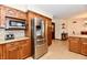 Kitchen with wood cabinets, granite countertops and stainless steel appliances at 1010 Lakewood N Dr, Brownsburg, IN 46112