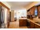 The kitchen features wooden cabinets, stainless steel appliances, and tile flooring at 1010 Lakewood N Dr, Brownsburg, IN 46112