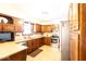 This functional kitchen boasts wooden cabinets, stainless steel appliances, and tile flooring at 1010 Lakewood N Dr, Brownsburg, IN 46112