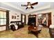 Cozy living room with tray ceiling, ceiling fan, and comfortable leather sofa at 1010 Lakewood N Dr, Brownsburg, IN 46112