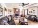Cozy living room featuring a fireplace, plush sofas, and a ceiling fan at 1010 Lakewood N Dr, Brownsburg, IN 46112