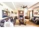 Cozy living room with a brick fireplace, leather furniture, and plenty of natural light at 1010 Lakewood N Dr, Brownsburg, IN 46112