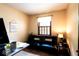 Cozy living room with a black futon, desk, and decor promoting a calming atmosphere at 1010 Lakewood N Dr, Brownsburg, IN 46112