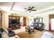 Comfortable living room featuring plush sofas, a ceiling fan, and an open doorway at 1010 Lakewood N Dr, Brownsburg, IN 46112