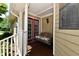 Cozy covered porch with a wooden swing and charming details at 1010 Lakewood N Dr, Brownsburg, IN 46112