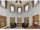 Cozy sitting area with multiple windows offering abundant natural light and comfortable leather chairs at 1010 Lakewood N Dr, Brownsburg, IN 46112