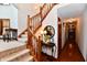 Elegant staircase with wood railing and carpeted steps, leading to upper level at 1010 Lakewood N Dr, Brownsburg, IN 46112