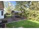 Outdoor patio featuring brick pavers, a metal gazebo, and a large yard with mature landscaping at 10245 Briar Creek Ln, Carmel, IN 46033