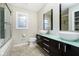 Modern bathroom featuring a double vanity, glass shower, and ample natural light at 10245 Briar Creek Ln, Carmel, IN 46033