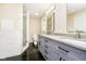Bright bathroom featuring double vanity, modern fixtures, and a walk-in shower with glass door at 10245 Briar Creek Ln, Carmel, IN 46033