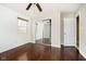 Bedroom showcasing wood floors, a sliding-door closet, and neutral paint at 10245 Briar Creek Ln, Carmel, IN 46033