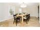 Formal dining room with tan tile flooring, a light wood table set for eight, and trim detail at 10245 Briar Creek Ln, Carmel, IN 46033