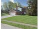 Well-kept home with attached garage, lush green lawn, and mature trees in a quiet neighborhood at 10245 Briar Creek Ln, Carmel, IN 46033