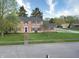 Inviting brick home with a well-manicured lawn, mature trees and a classic brick walkway at 10245 Briar Creek Ln, Carmel, IN 46033