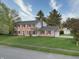 Well-maintained brick house with a two-car garage and a spacious lawn with mature trees at 10245 Briar Creek Ln, Carmel, IN 46033
