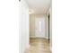 Entryway with white front door with decorative window, light wood flooring, and white closet door at 10245 Briar Creek Ln, Carmel, IN 46033