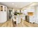 Bright, modern kitchen with white cabinets, stainless steel appliances, and an island with seating at 10245 Briar Creek Ln, Carmel, IN 46033